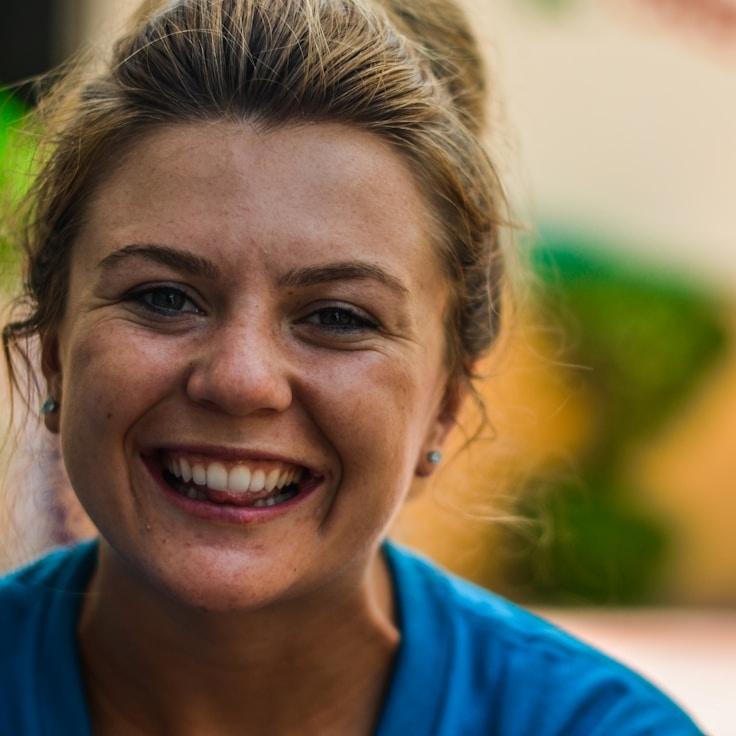 Avery Chen, Lead Design Curator at ConverSaneXusium, reviewing corporate floral arrangements